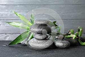 Stacked zen stones and bamboo leaves on table