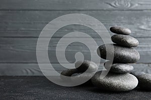 Stacked zen stones on table against wooden background