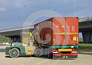 Stacker lifting a container photo