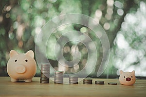 Stacking coins pile and cute pink piggy bank for savings money