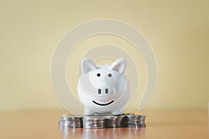 Stacking coins pile and white piggy bank for savings with money and planning step up to growing,