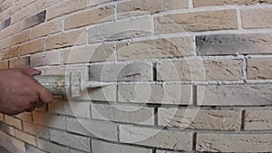 Stacking of a decorative stone on a wall, repair work