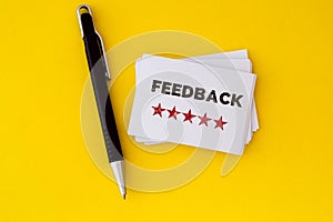 Stacking of Feedback with five star drawn on white business card , a excellent customer satisfaction feedback concept