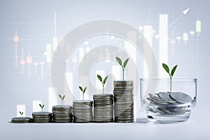 Stacking of money coins and a glass jar with plants growing on top for business, financial, accounting, banking, saving money