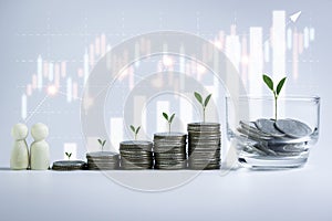 Stacking of money coins, wooden dolls and a glass jar with plants growing on top for business, financial, accounting, banking