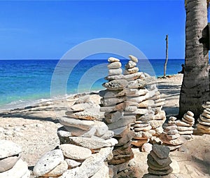 Stacking rocks in a beach at Isla Gigantes, Carles, Iloilo