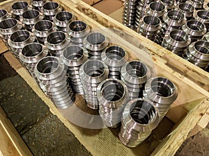 stacks of batch production round parts in a wooden boxes on factory floor
