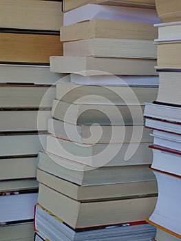 Stacks of books, close-up for background, vertical