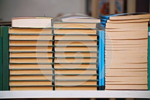 Stacks of books on a shelf in the library