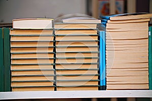 Stacks of books on a shelf in the library