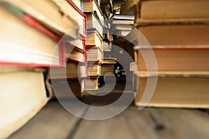 Stacks of books stand in rows on the table. Book photo from bottom to top. Macro photography of stacks of books on the