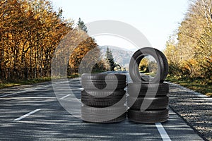 Stacks of car tires on asphalt highway