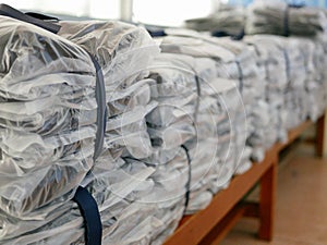 Stacks of clothes packed in plastic bags ready to be shipped / distributed