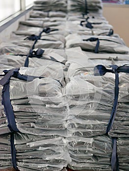 Stacks of clothes packed in plastic bags ready to be shipped / distributed