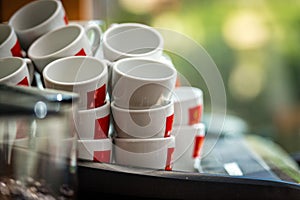 Stacks of coffee cups on coffee machine
