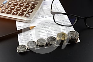 Stacks of Coin and and calculator on Banking Account for Business Finance Concept