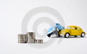 Stacks of coins on the background of a car accident on a light background. Car accident insurance concept.