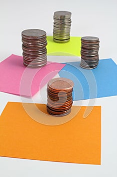 Stacks of coins on blank color notes