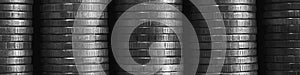 Stacks of coins close-up. Coin texture. Black and white business banner. Header made of many coin edges. Economy finance and