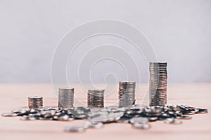 Stacks of coins growing on a wooden table. The concept of the growth of the investment and deposit economy.