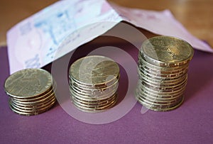 stacks of coins from the Ukrainian bank. Coins of Ukrainian type: Kopek. Concept of banking, taxes, debt, with a blurred