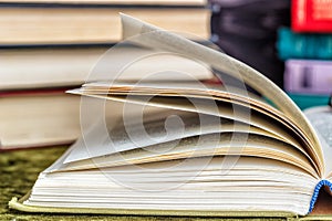 Stacks of colored books on a wooden table. concept of reading habits