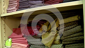 Stacks of colorful fabrics on shelves