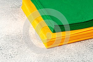 Stacks of colorful paper napkins on gray background