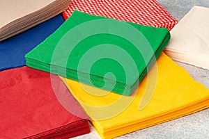 Stacks of colorful paper napkins on gray background