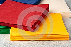 Stacks of colorful paper napkins on gray background