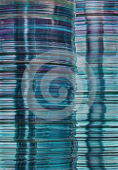 Stacks of translucent blue CD and DVD data storage disks