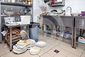 Metal sink full of dirty dishes, crockery, tableware