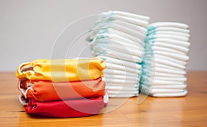 Stacks of disposable diapers and modern cloth diapers