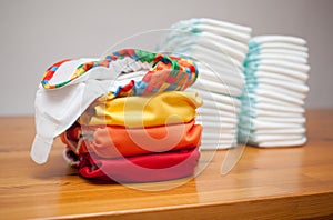 Stacks of disposable diapers and modern cloth diapers