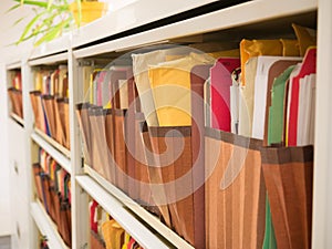 Stacks of document paper and files folder in a filing cabinet