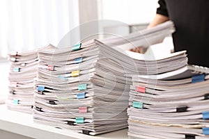 Stacks of documents with paper clips