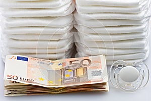 Stacks of Euro Banknotes Diapers and Pacifier
