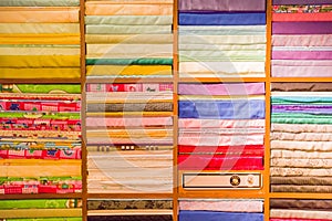 Stacks of folded clothing on the shop shelves