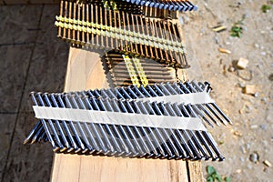 Stacks of framing nails sitting on the windowsill of a house under construction in a new residential community under construction