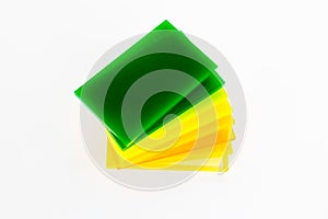 Stacks of green yellow pieces of Plexiglas