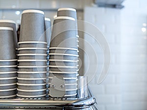 Stacks of grey paper cups and coffee cups photo