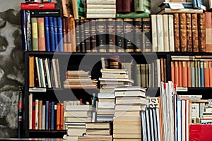 Stacks of many old used books and magazines displayed at local antiquarian bookshop