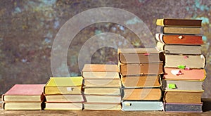 Stacks of multicolored books. Reading,literature,education,library,home office concept,grungy background,copy space