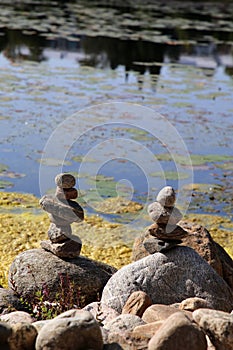 Relaxing, Zen Like View Including Stacks of Natural Rocks and a Lake during a Sunny Day