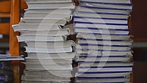 Stacks of old books or textbooks on table