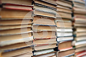 Stacks of old hardback and paperback books. Background image