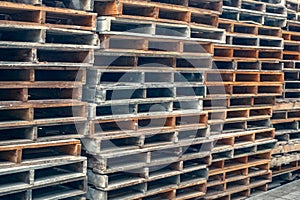 Stacks of old wooden pallets in an industrial yard