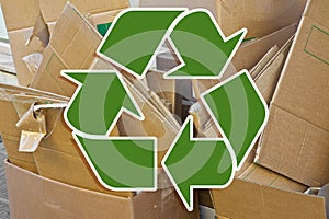 Stacks of paper and cardboard ready to be recycled - Recovery and recycling concept with recycling symbol