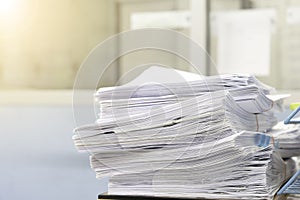 Stacks of paper files work desk office, business report papers,piles of unfinished documents, Business concept
