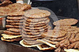 Stacks of Pljeskavica, grilled burger of spiced meat patty mixture of pork, beef and lamb. It is a national dish of Serbia photo